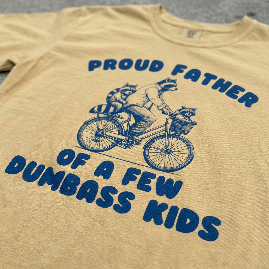 TeeHeeUSCo PROUD FATHER OF A FEW D*MBASS KIDS Yellow zoomed detail shot graphic tee