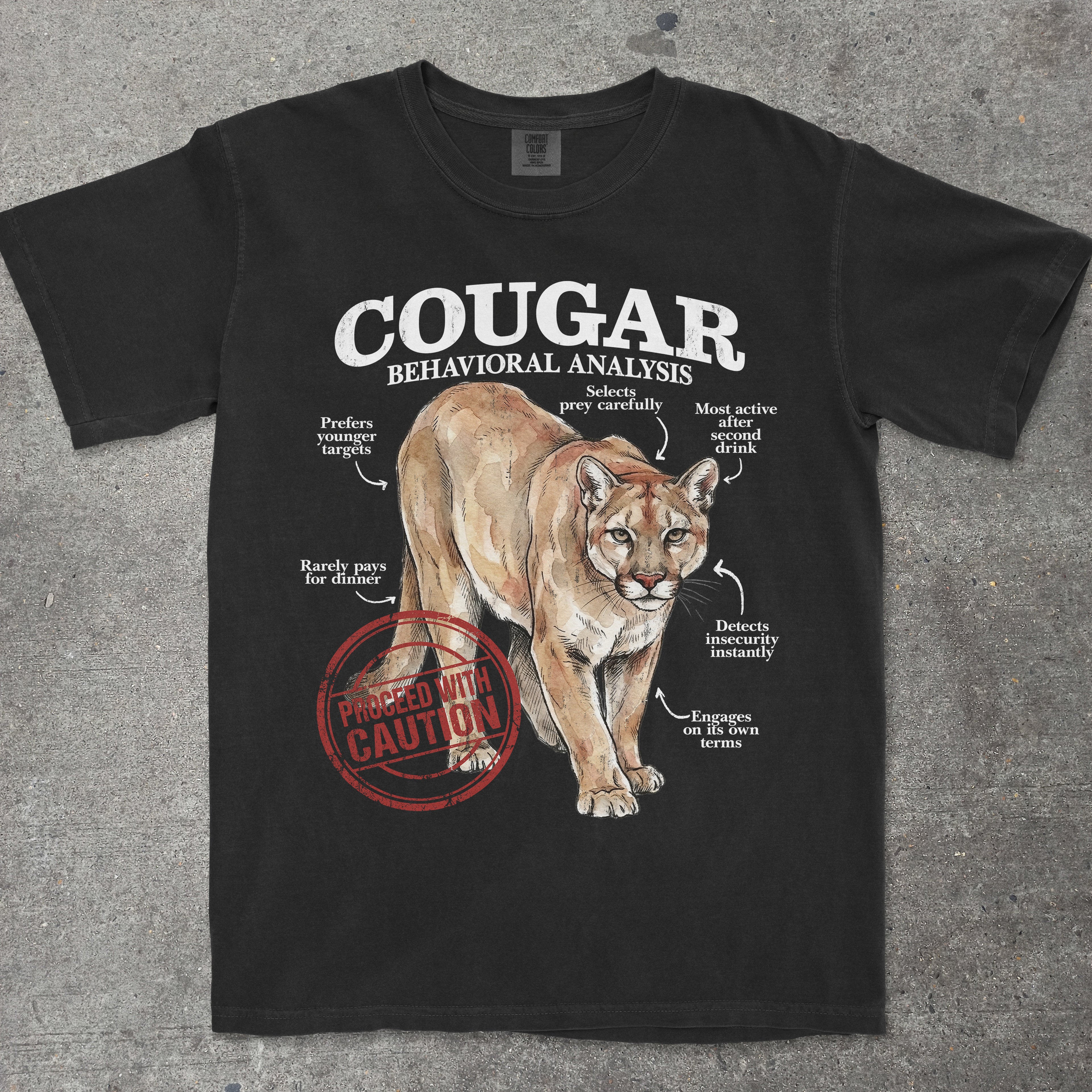 Black t-shirt with a cougar graphic and text on a gray surface