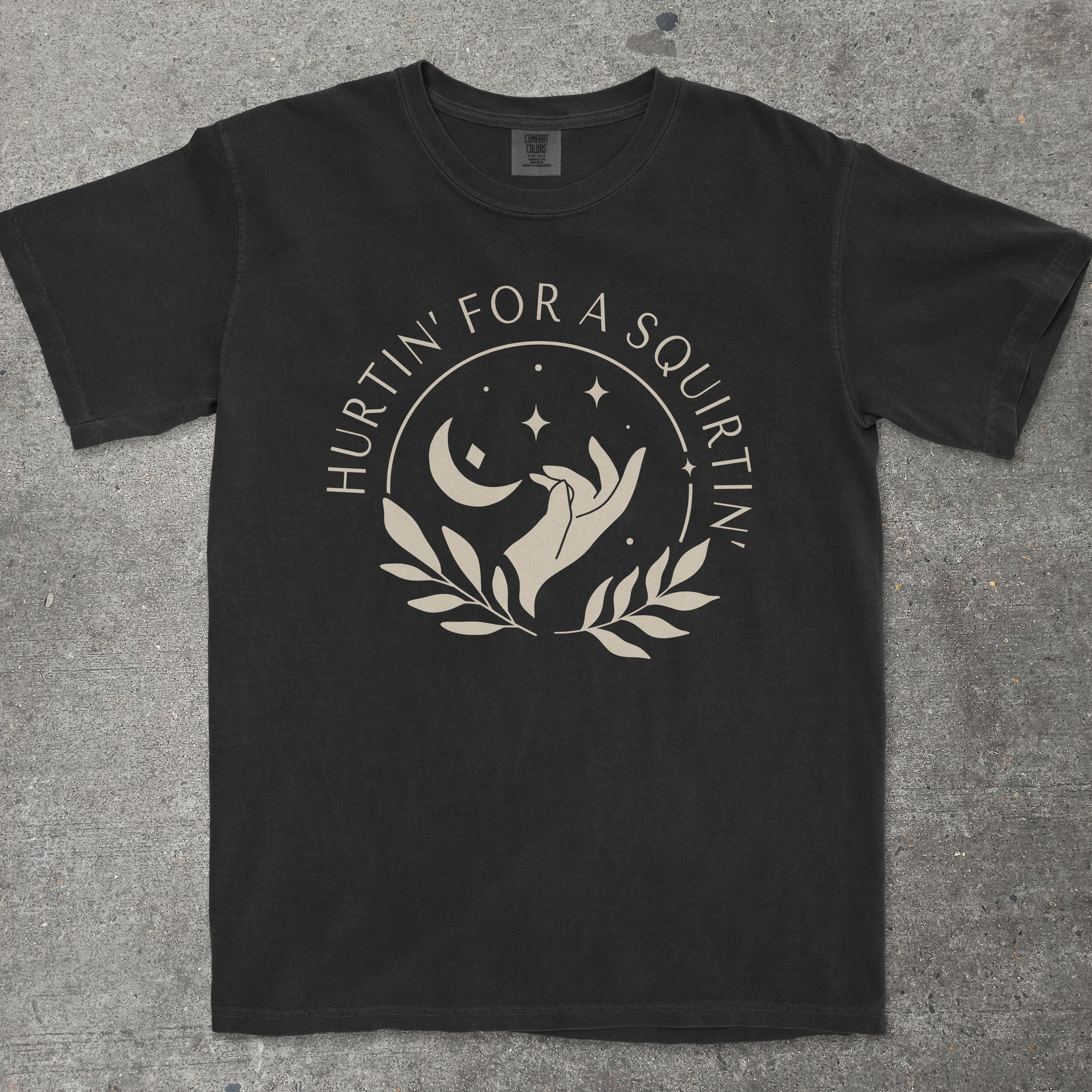 Black t-shirt with white graphic design on a gray surface