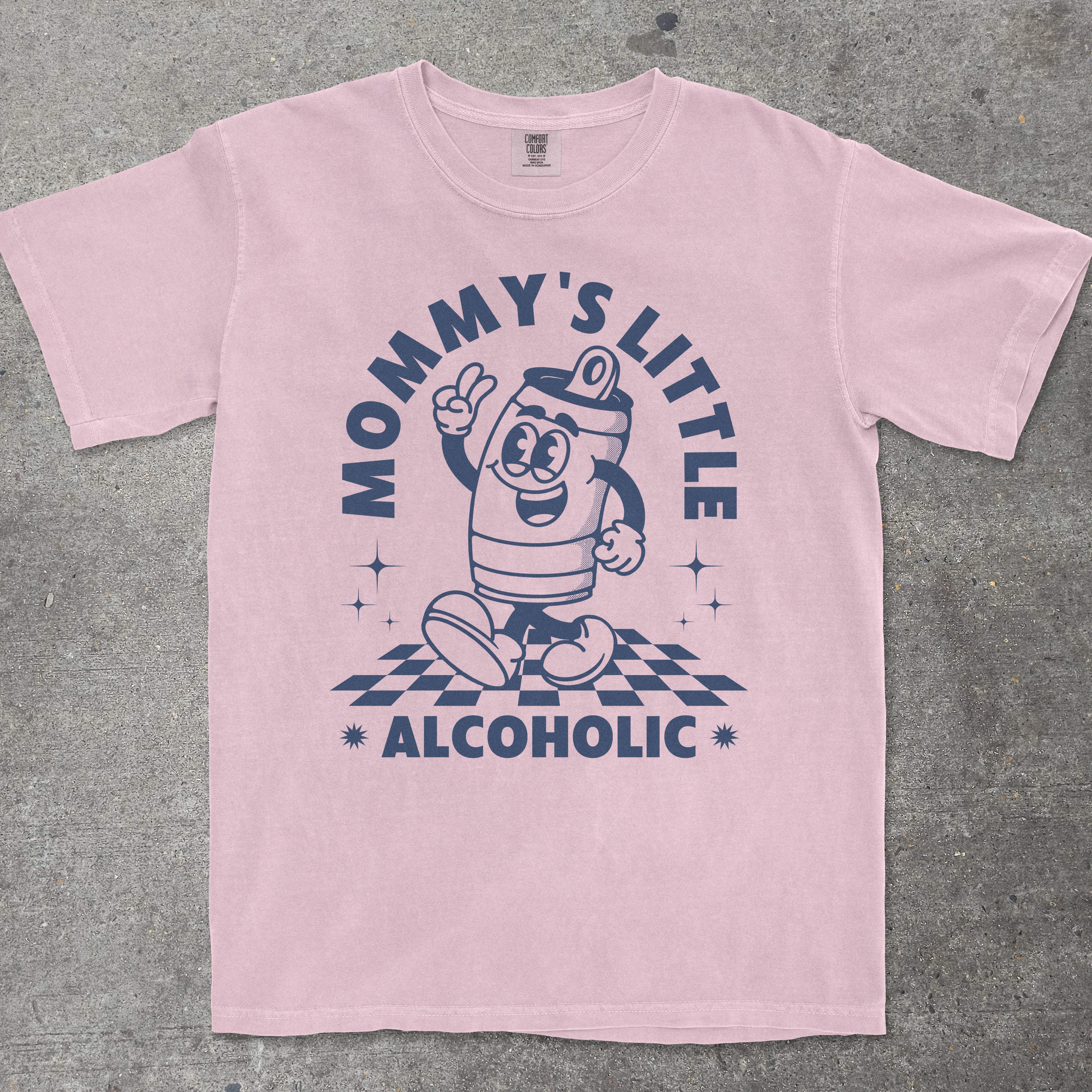 Pink t-shirt with a cartoon character and text on a gray background