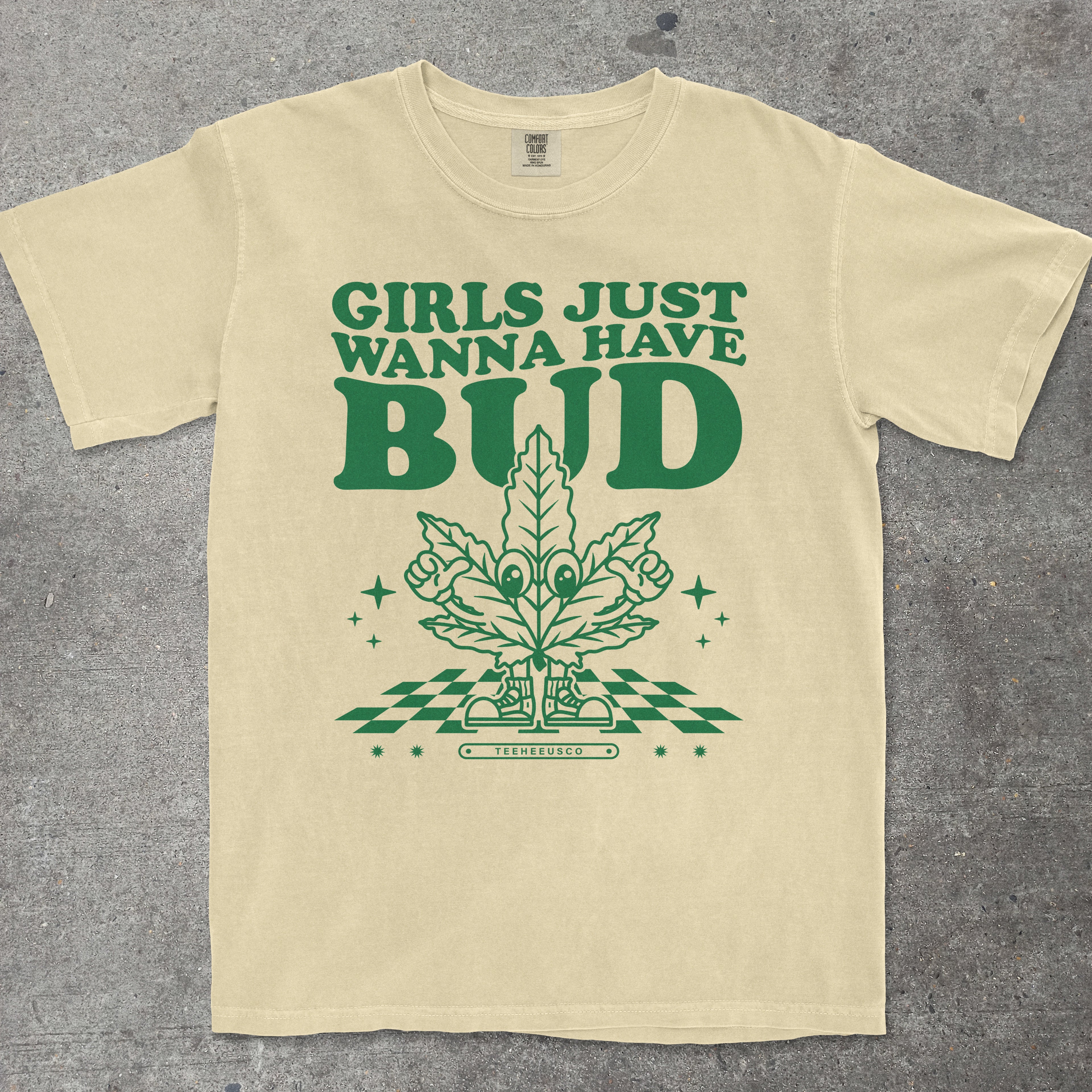 Yellow t-shirt with green graphic and text 'Girls Just Wanna Have Bud' on a gray background