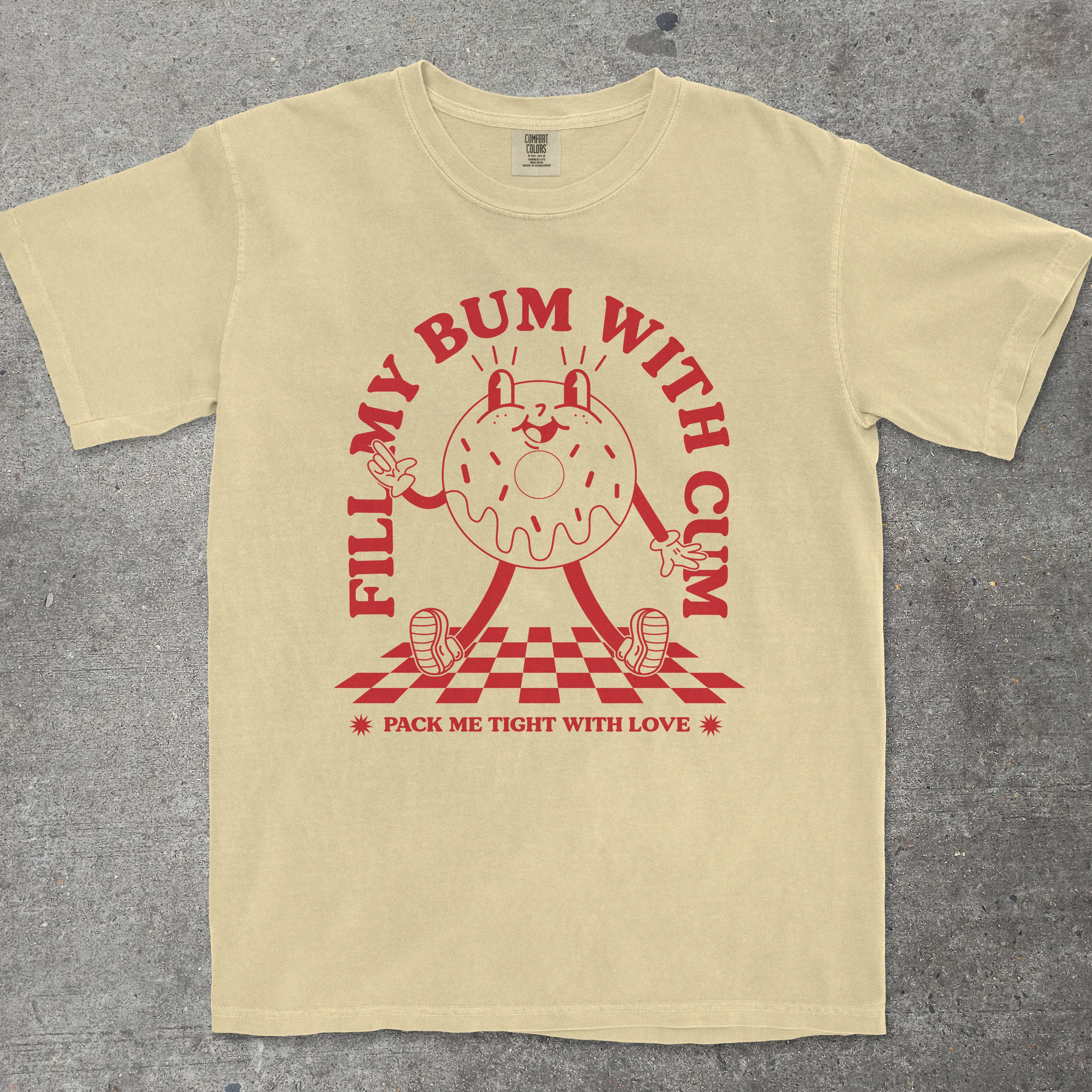 Yellow t-shirt with red graphic design on a gray surface