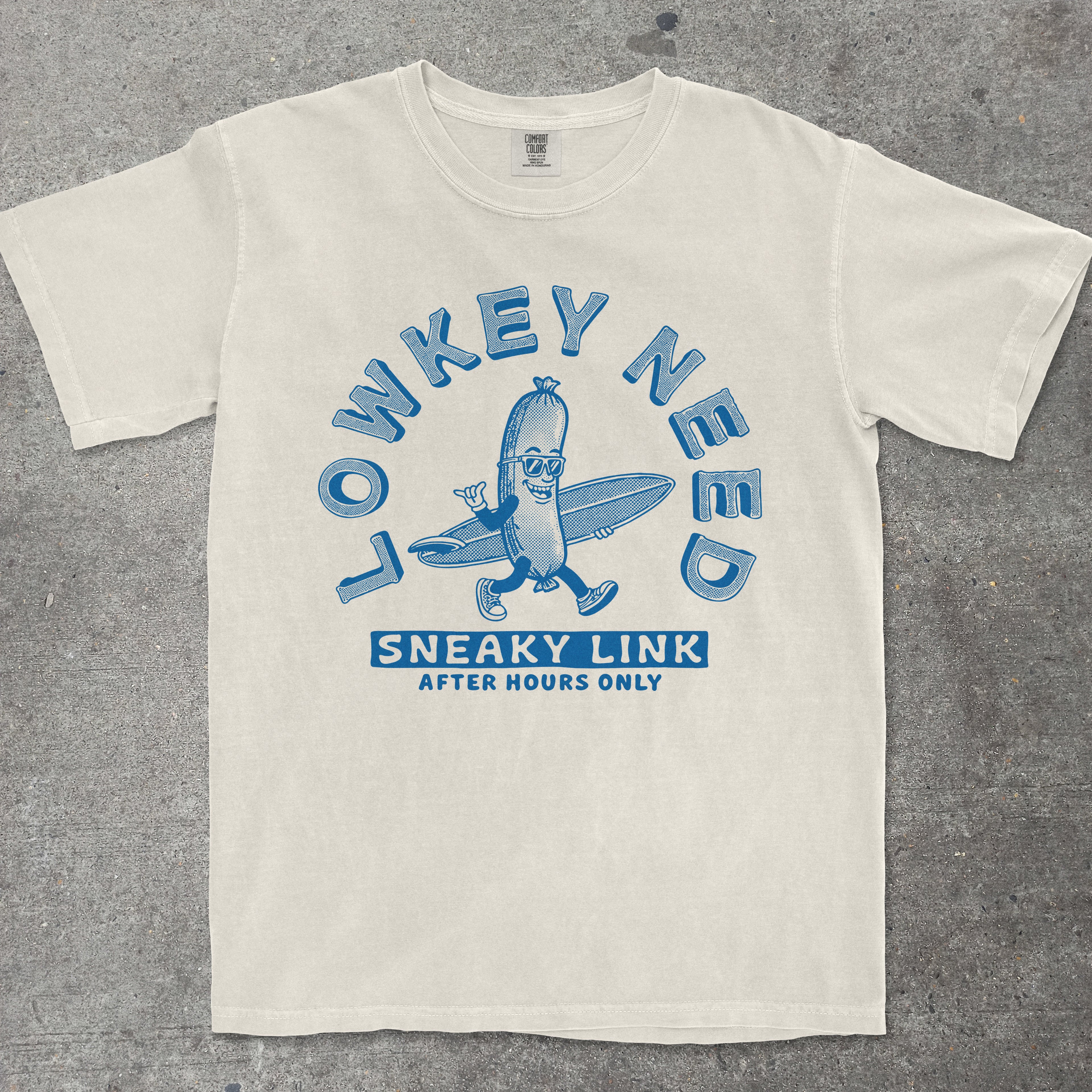 Ivory graphic tee featuring retro mascot character with "Lowkey Need a Sneaky Link - After Hours Only" text by TeeHeeUSCo
