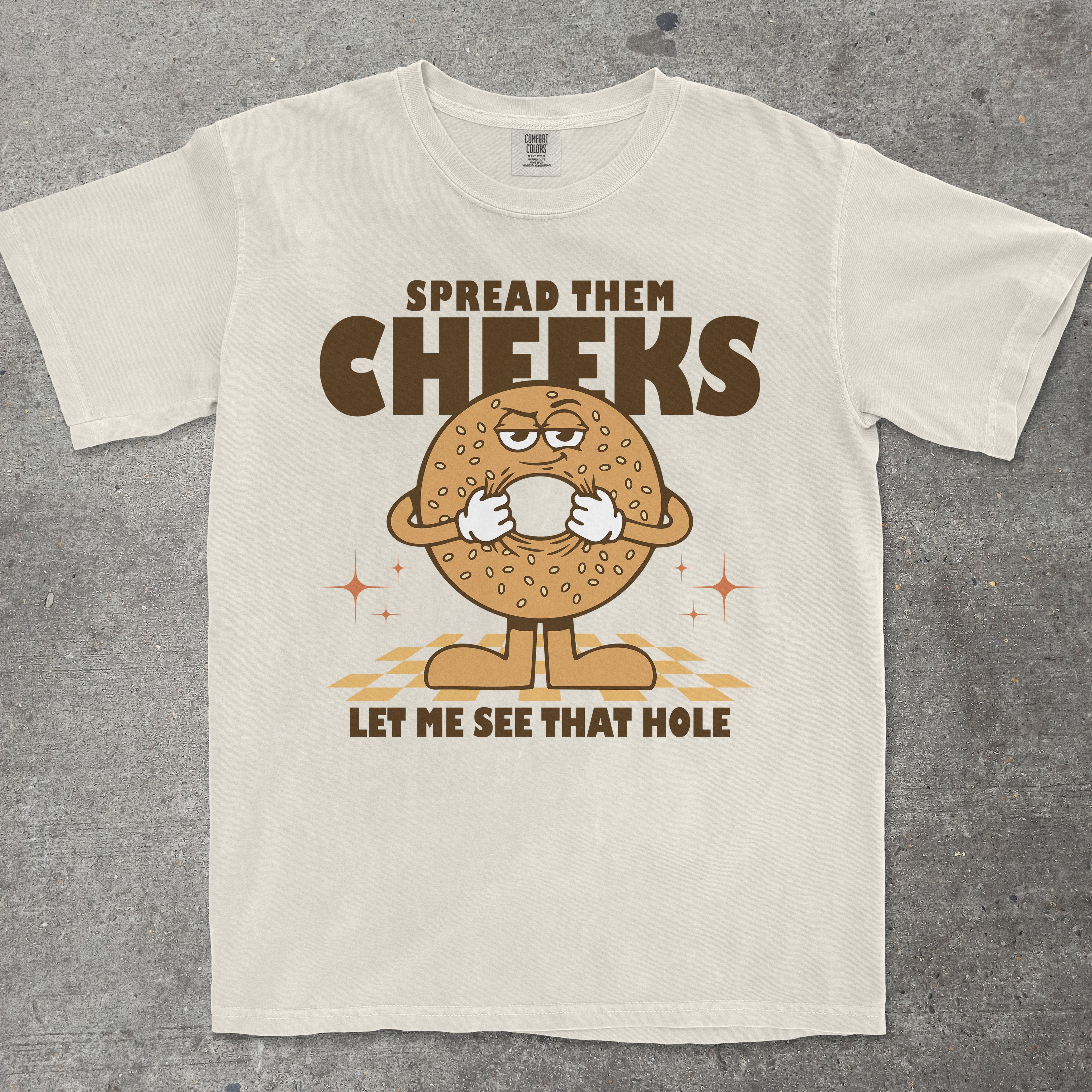 T-shirt with a cartoon bagel character and humorous text on a gray background