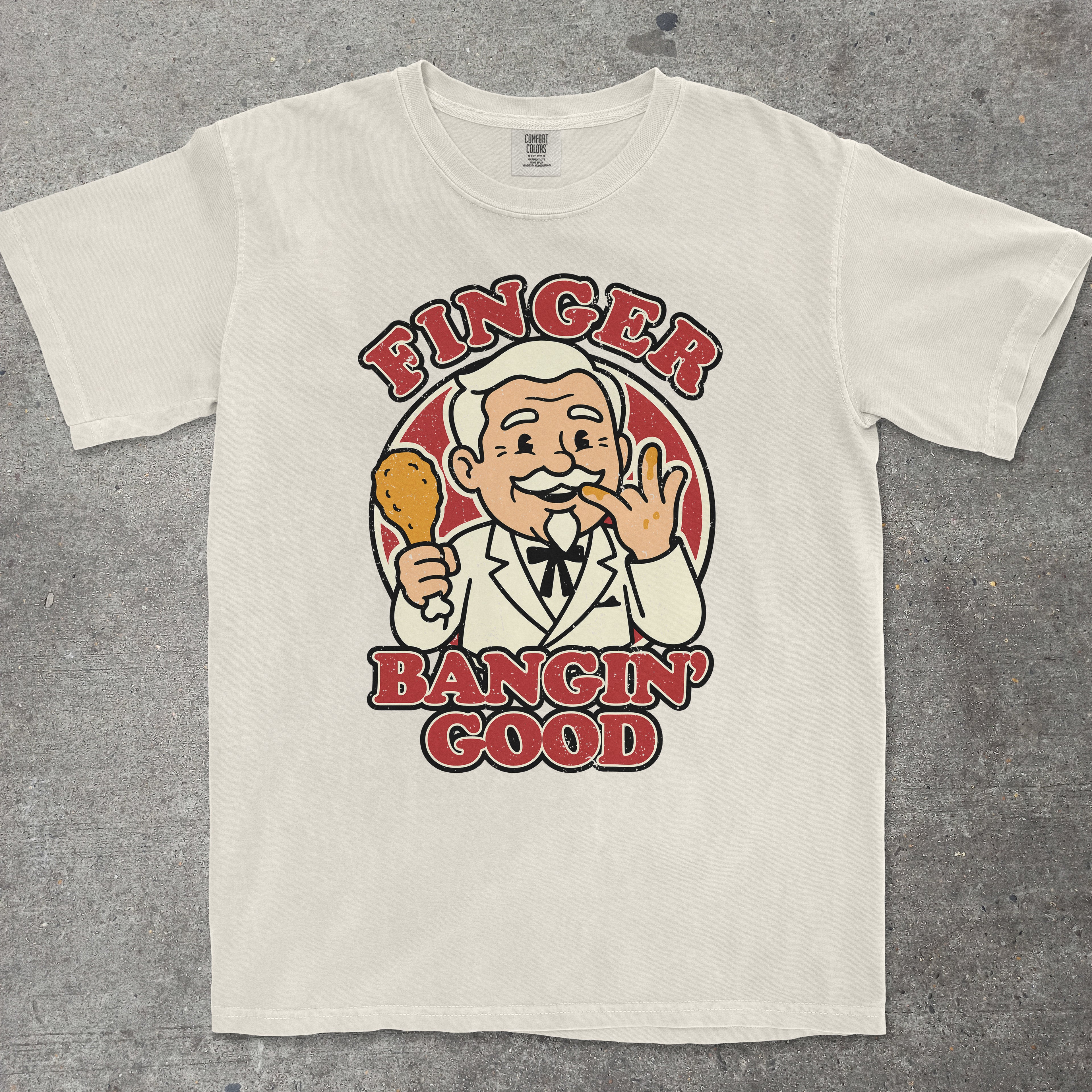 Ivory graphic tee with retro mascot character and "Finger Bangin Good" text design by TeeHeeUSCo
