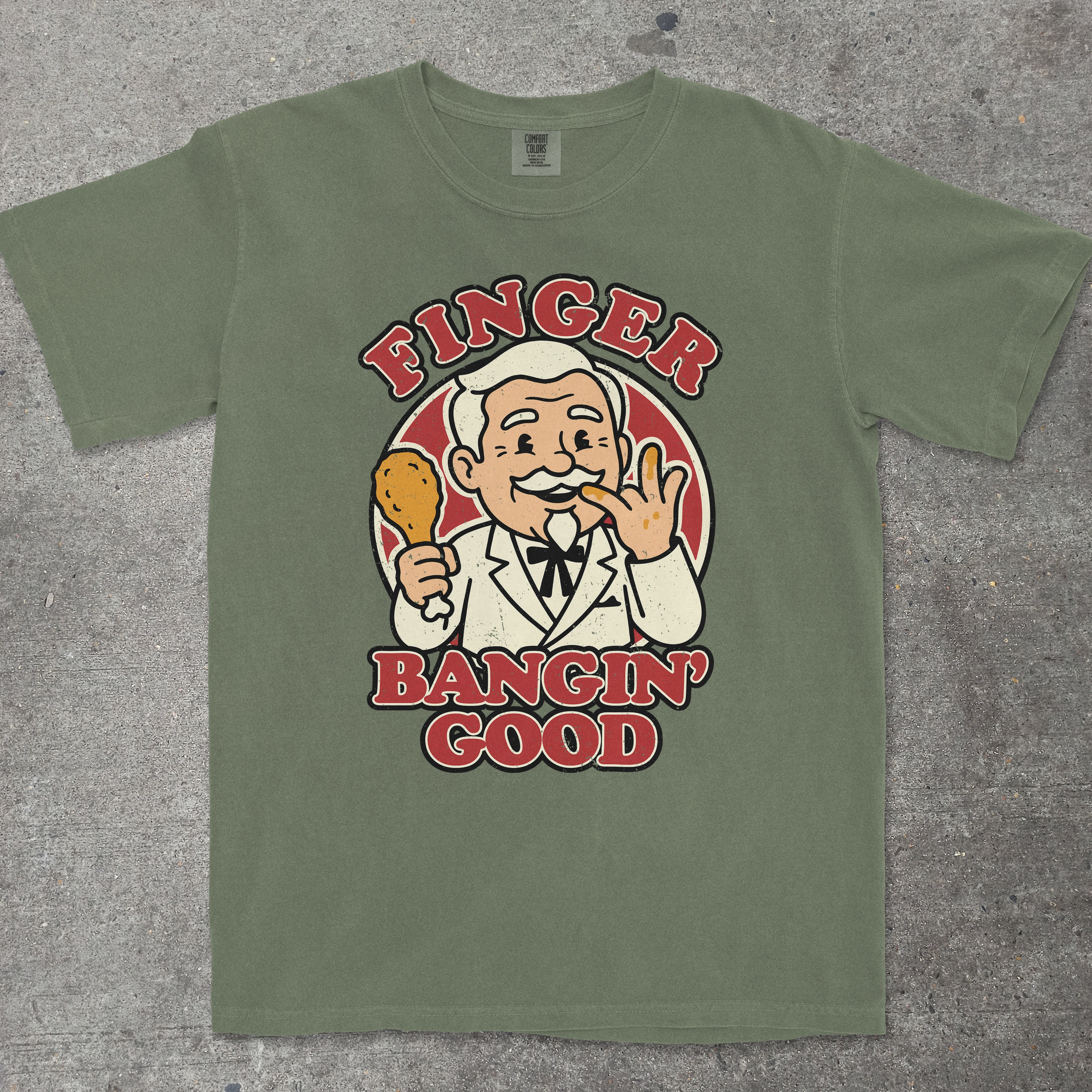 Moss green graphic tee with vintage mascot character and "Finger Bangin' Good" text by TeeHeeUSCo