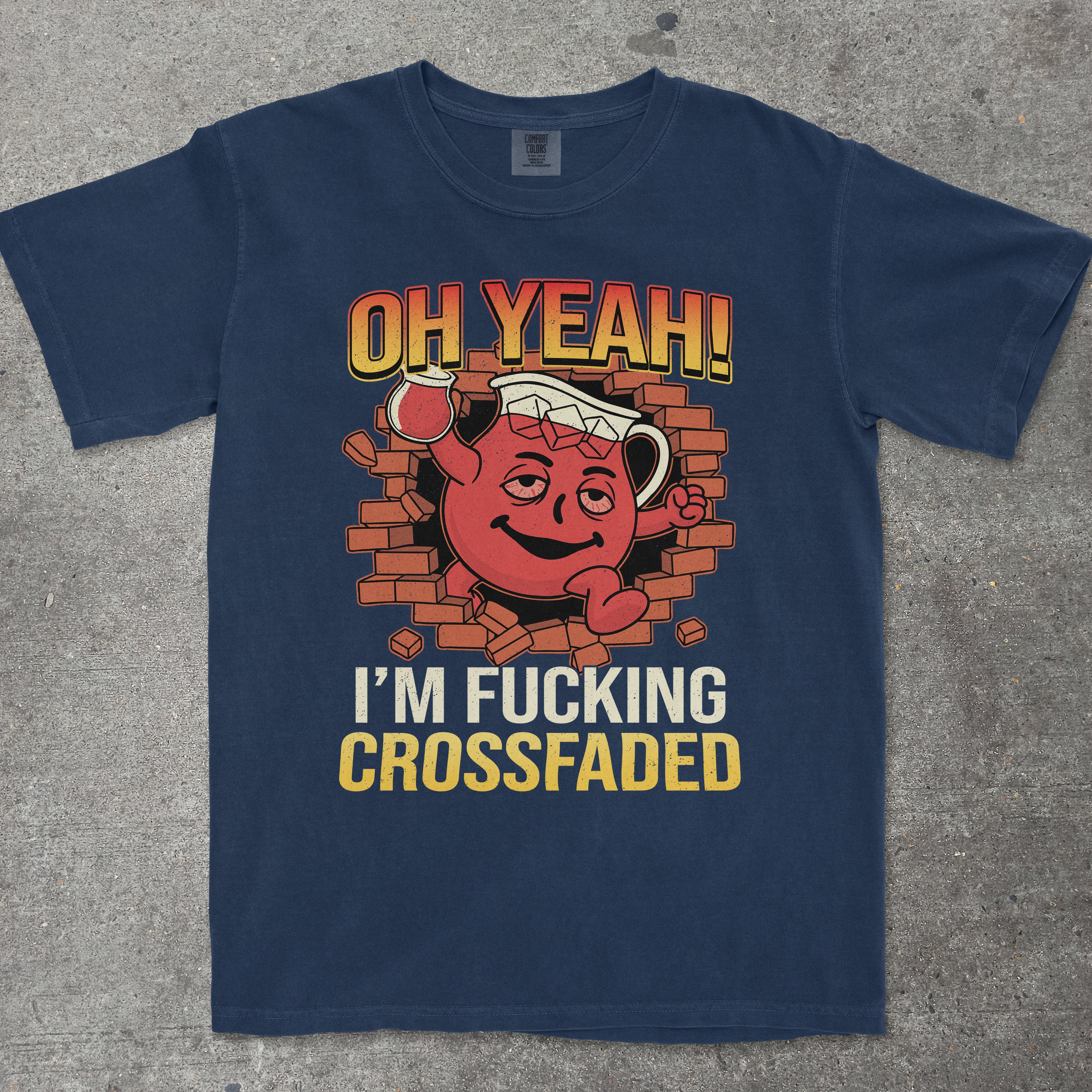 Navy blue t-shirt with a graphic design featuring a red character and text on a concrete surface.