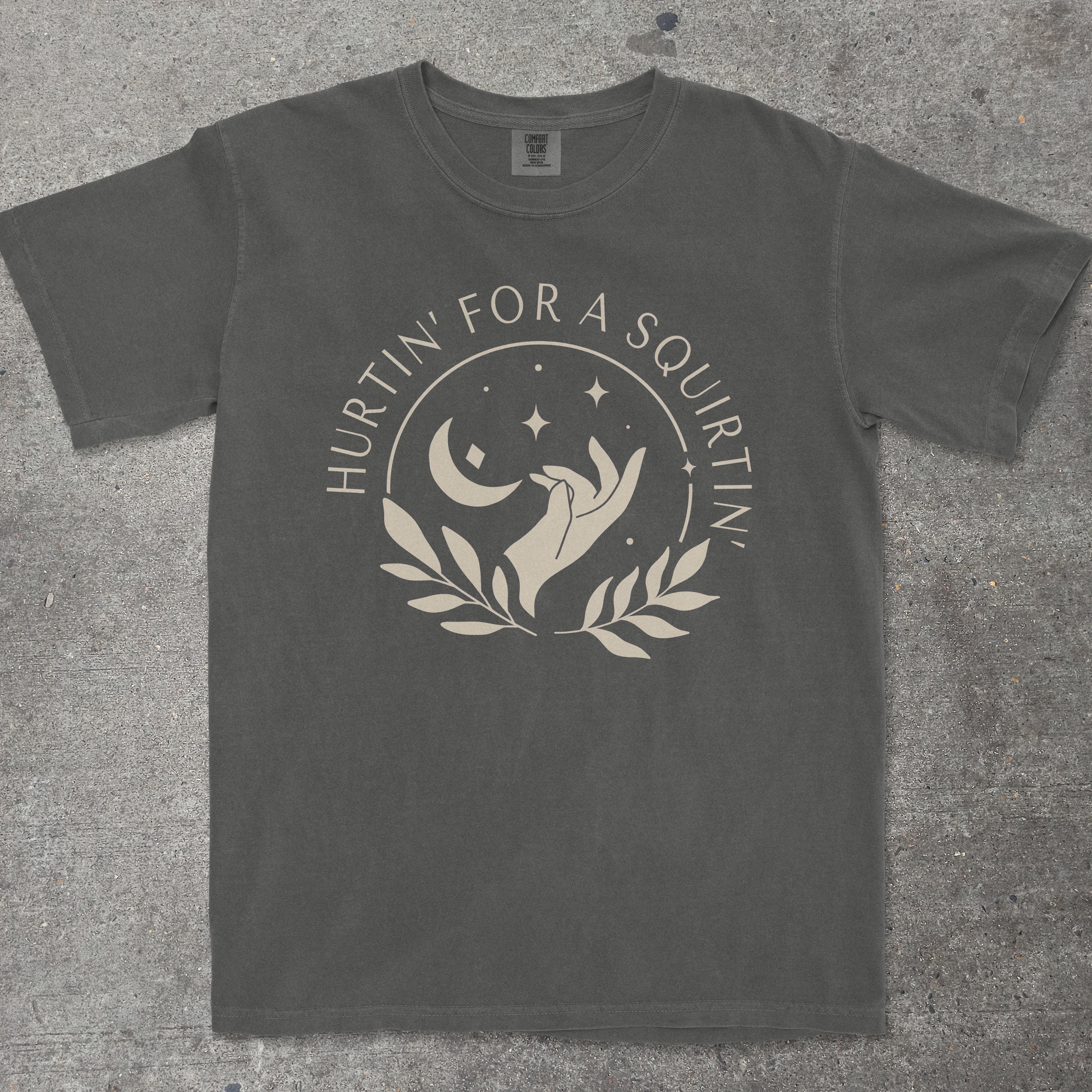 Dark gray t-shirt with a graphic design and text on a textured surface