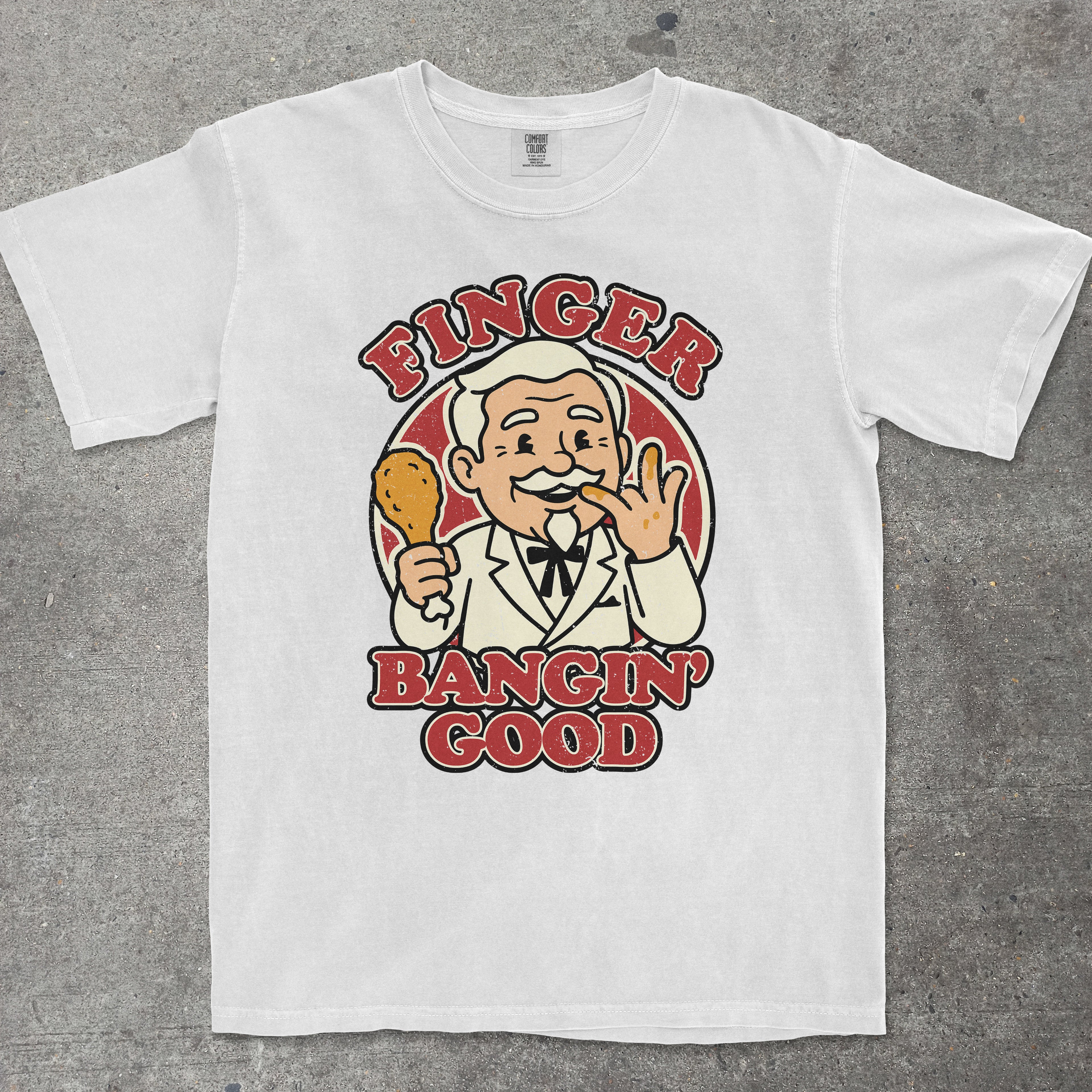 White graphic tee with vintage fast food mascot and "Finger Bangin Good" text by TeeHeeUSCo
