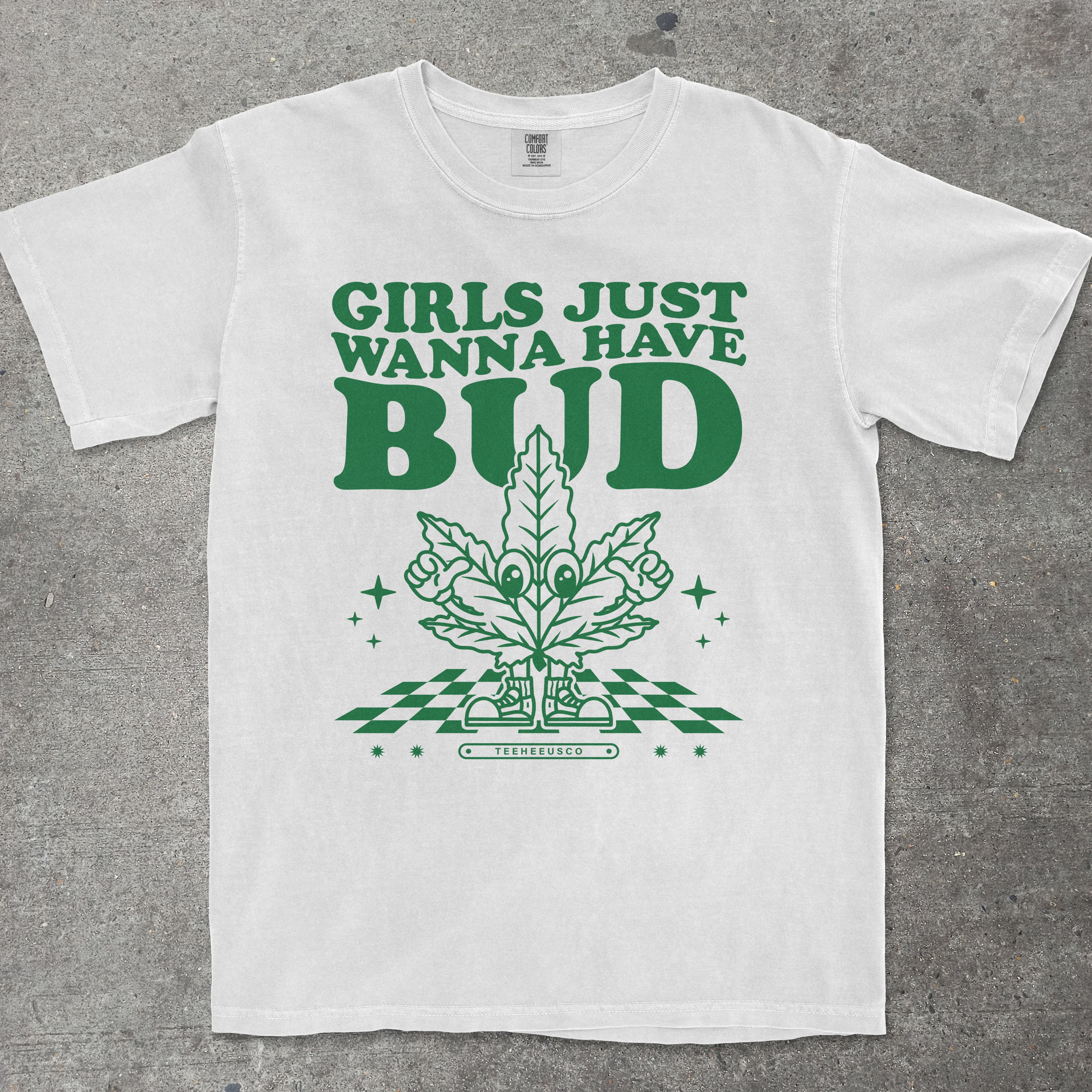 White t-shirt with green graphic and text 'Girls Just Wanna Have Bud' on a gray background